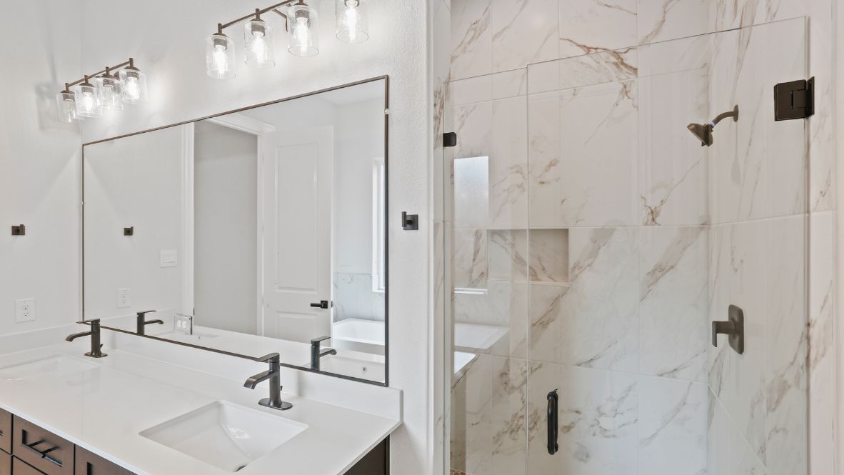 bathroom with dual vanity sinks, toilet, bath tub and a walk in shower