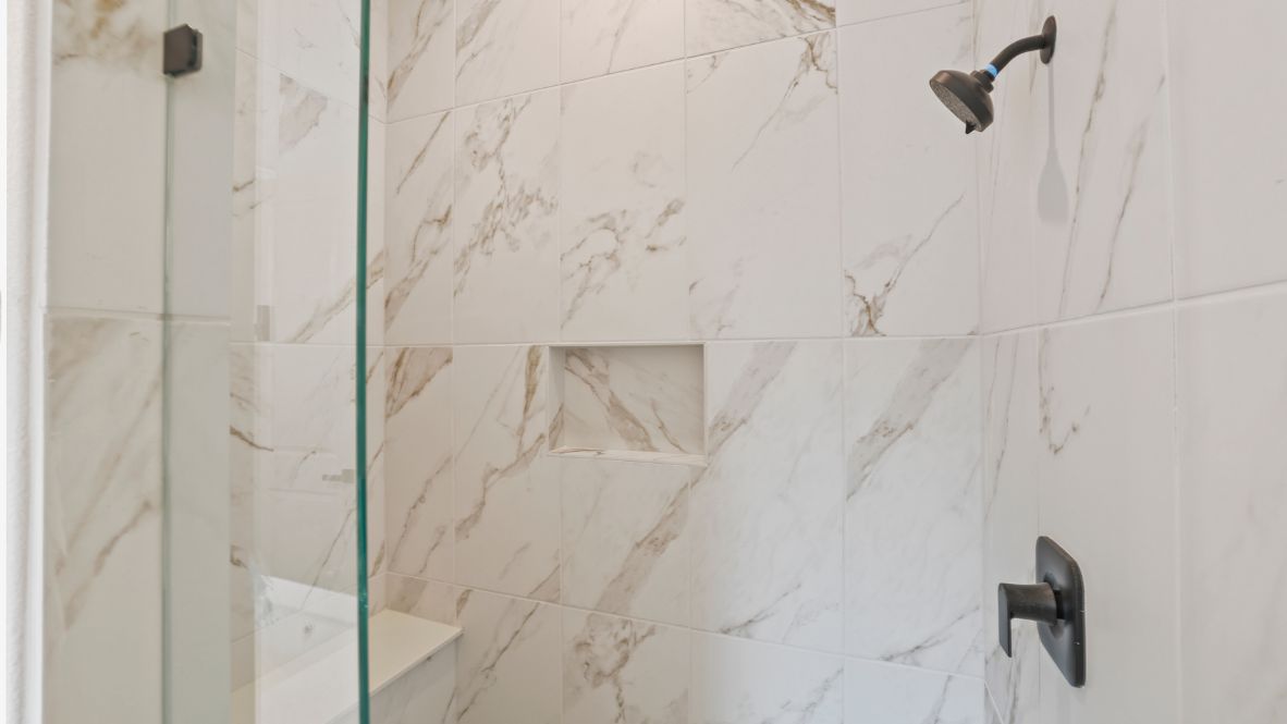 bathroom with dual vanity sinks, toilet, bath tub and a walk in shower