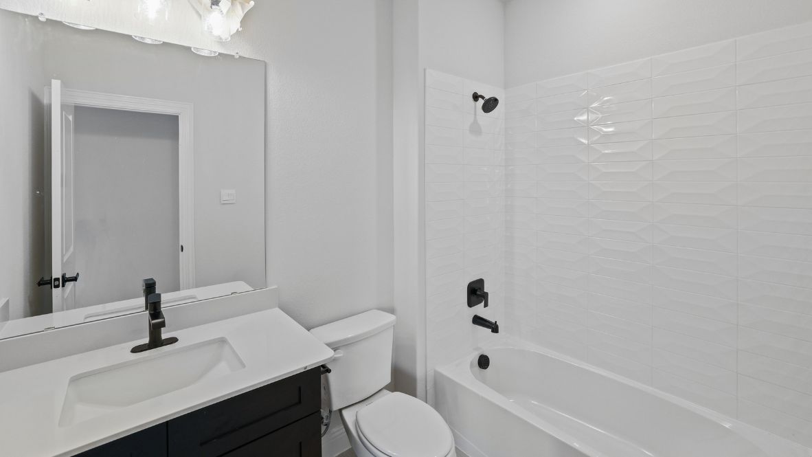 bathroom with a vanity sink, toilet and shower