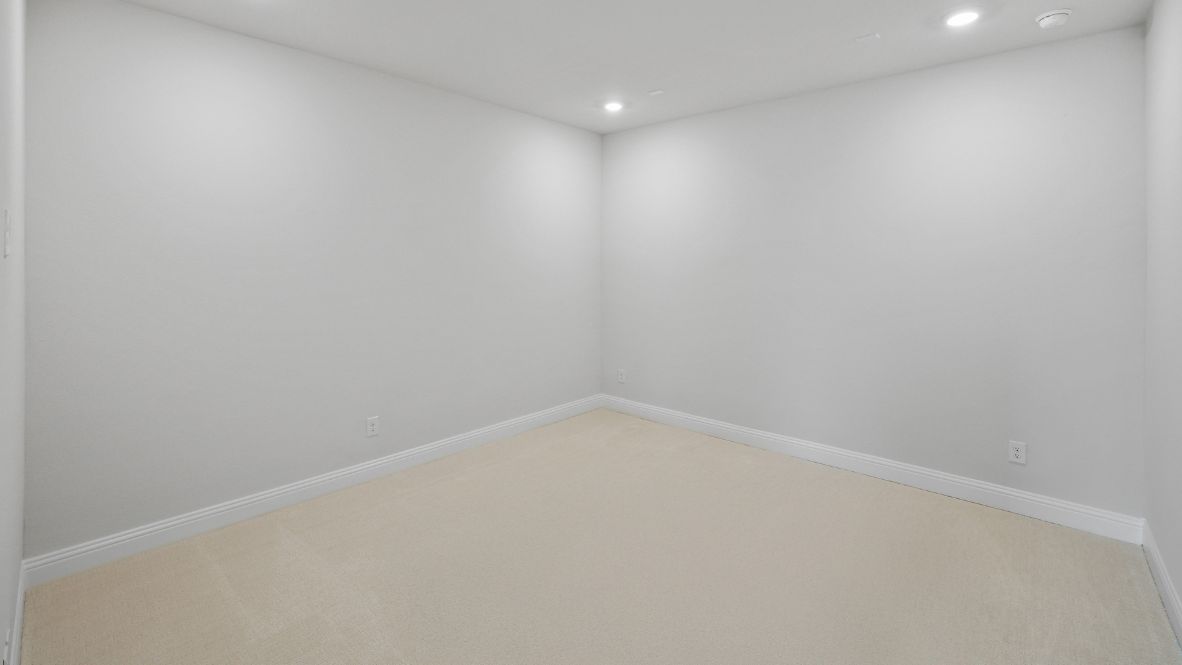 media room with beige carpet and grey walls