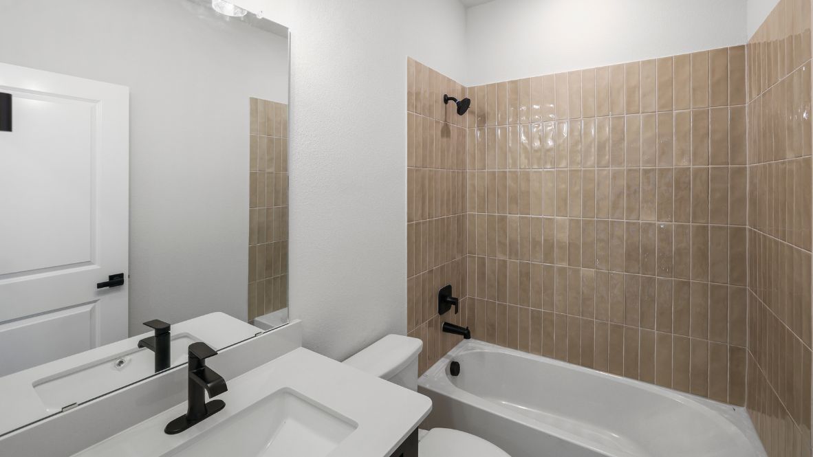 bathroom with a vanity sink, toilet and shower
