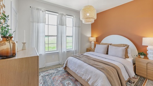 Interior bedroom with accent wall and large window