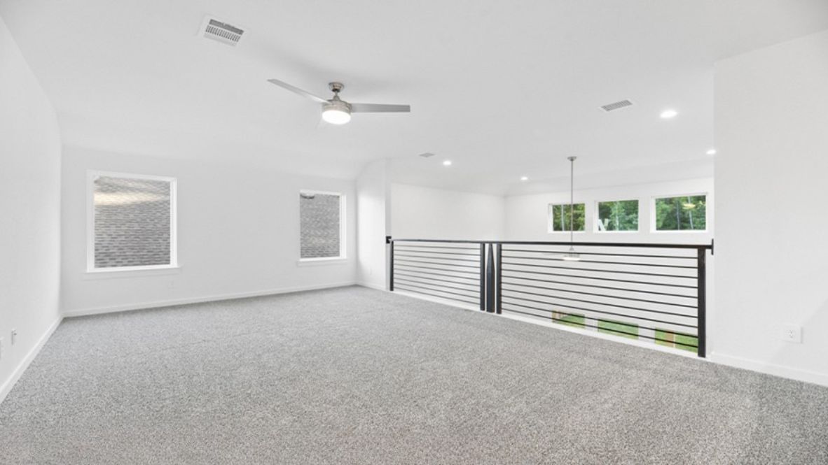 Ascending the staircase, you’ll find yourself in an open loft area, perfect for a media room, game room, or secondary living space. The double-height ceiling overlooking the living room below adds a sense of openness and grandeur.