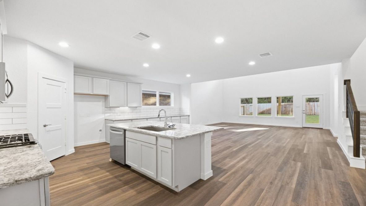 As you step inside, you’re welcomed into a spacious and inviting foyer that flows seamlessly into the heart of the home. To your left, a cozy guest bedroom or office sits conveniently near a full bathroom, perfect for visitors or a productive work-from-home setup.