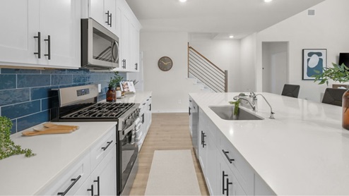Interior kitchen with center island and decorative backsplash