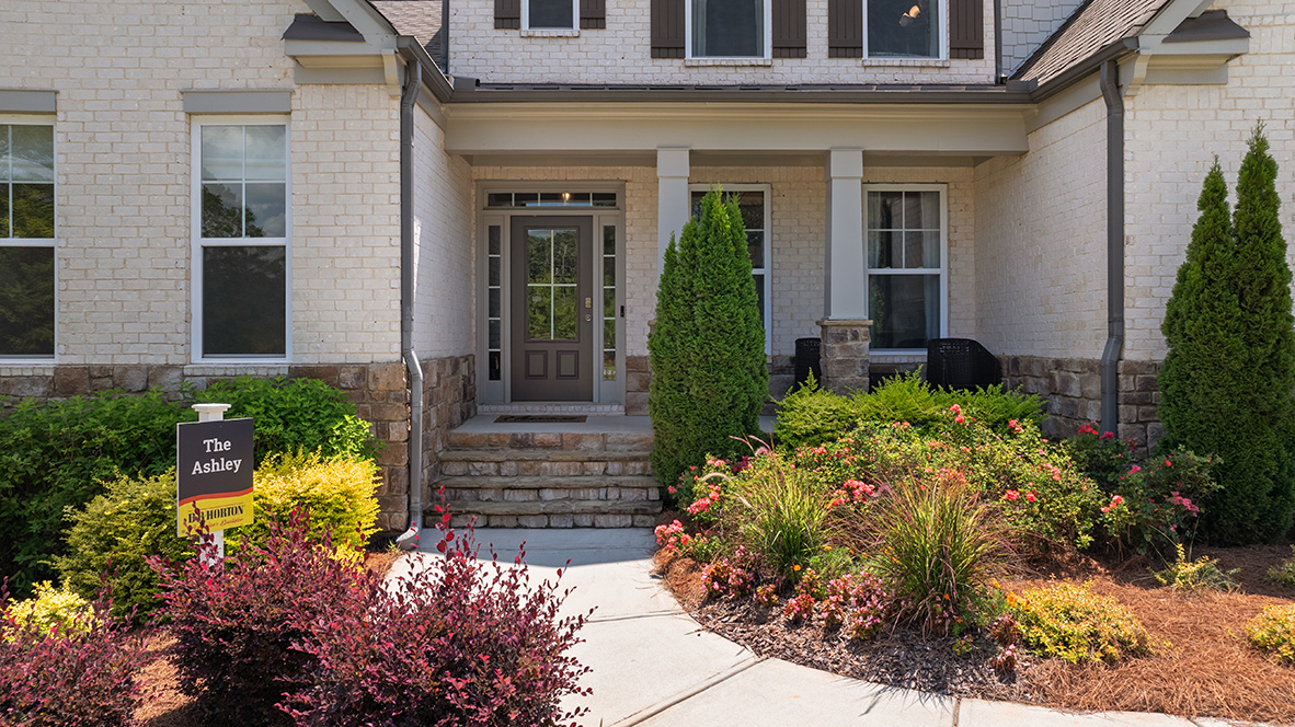 ashley model home front entryway and porch with beautiful landscaping