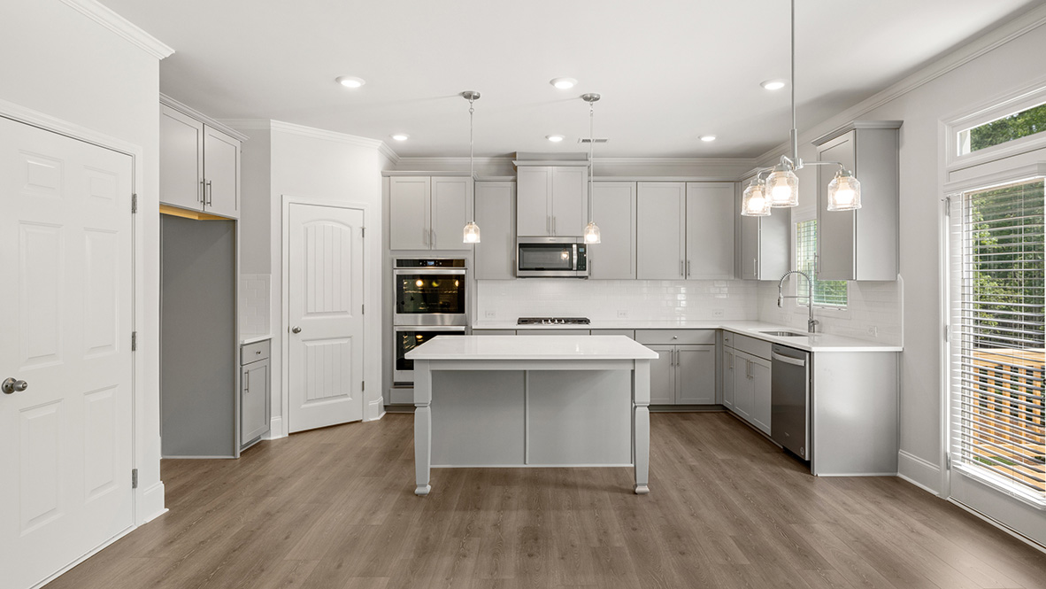 savannah II kitchen with white cabinets and granite countertops at gensee in newnan georgia