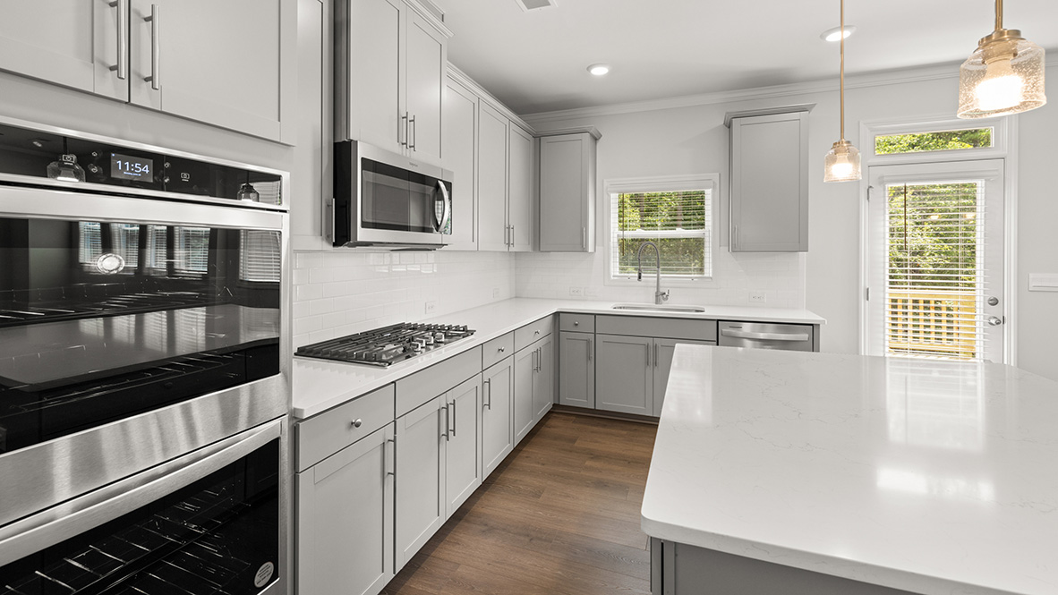 savannah II kitchen with white cabinets and granite countertops at gensee in newnan georgia