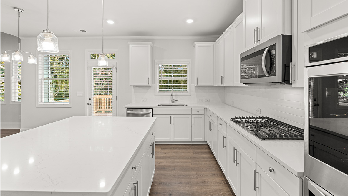savannah II kitchen with white cabinets and granite countertops at gensee in newnan georgia