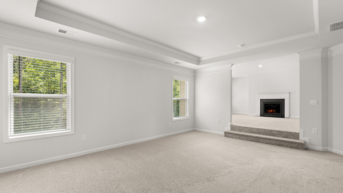 savannah II primary bedroom with sitting room with fireplace  at gensee in newnan georgia