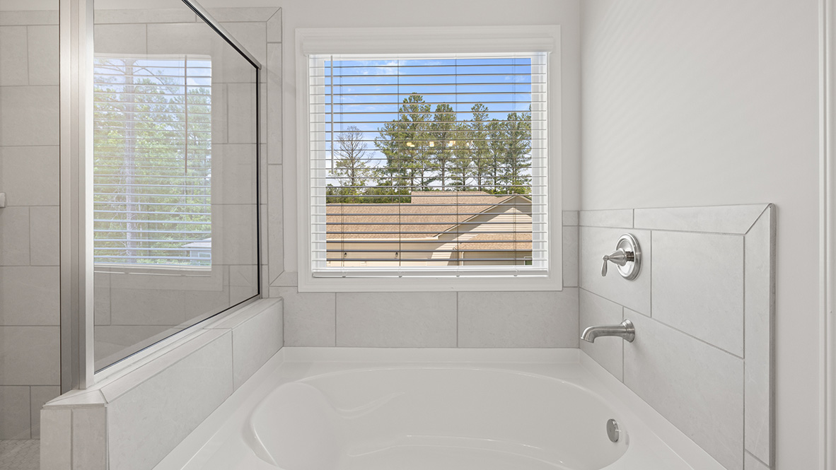 savannah II primary bathroom with soaking tub at gensee in newnan georgia