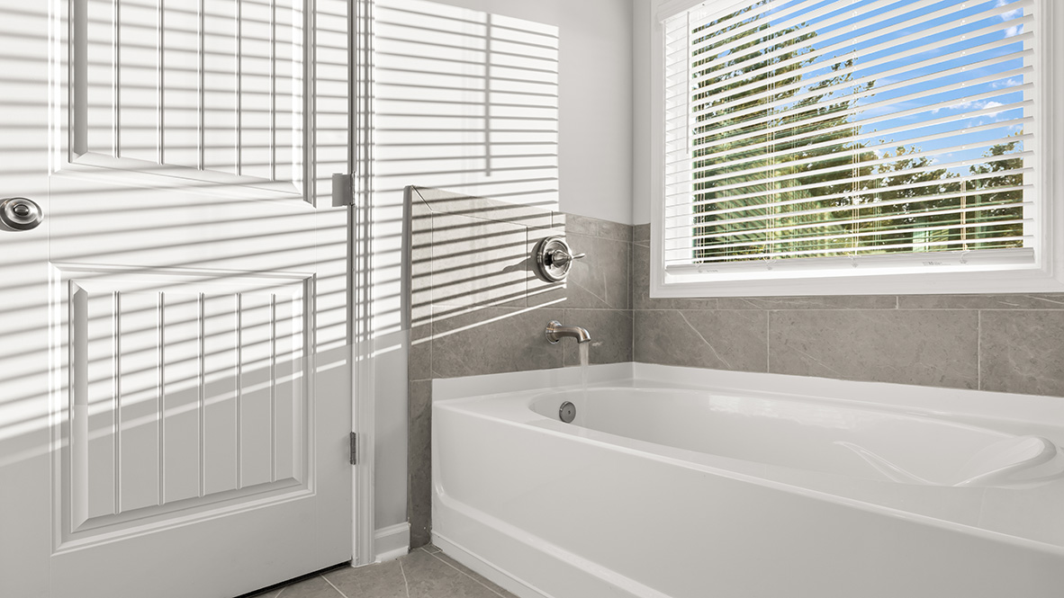 savannah II primary bathroom with soaking tub at gensee in newnan georgia