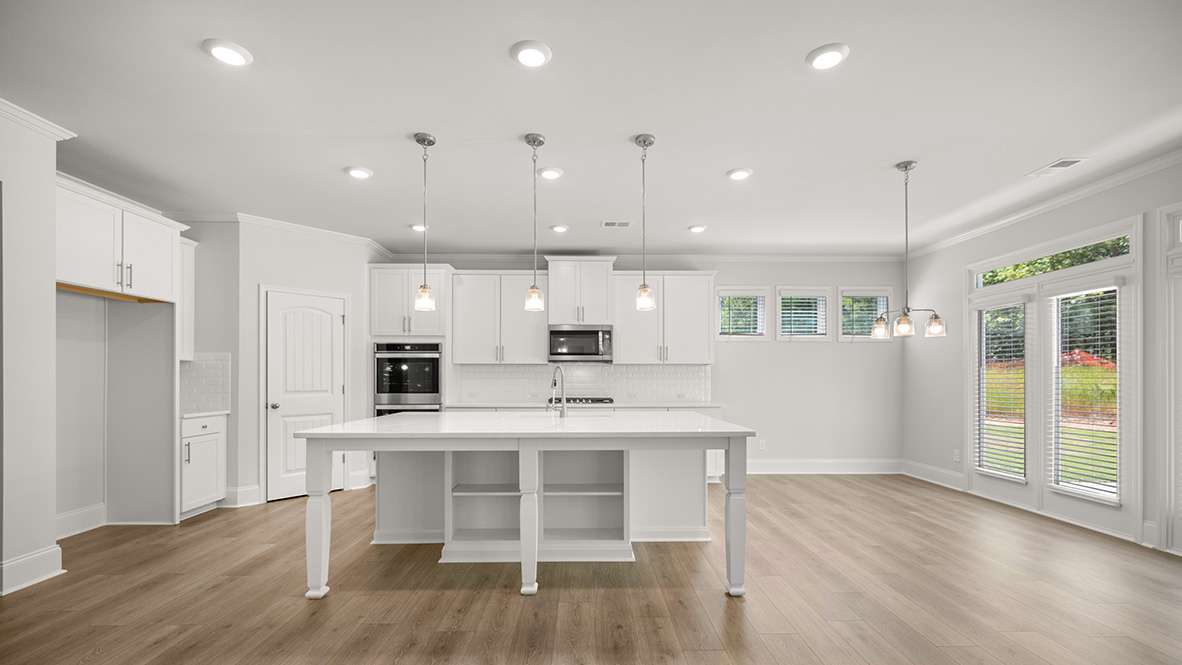 sonoma kitchen with large granite island and white cabinets at genesee in newnan georgia
