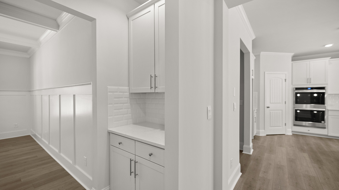 sonoma kitchen with large granite island and white cabinets at genesee in newnan georgia