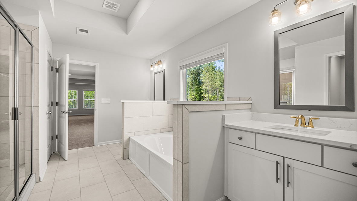 sonoma primary bathroom with seperate vanities and tub and soaking shower at genesee in newnan georgia