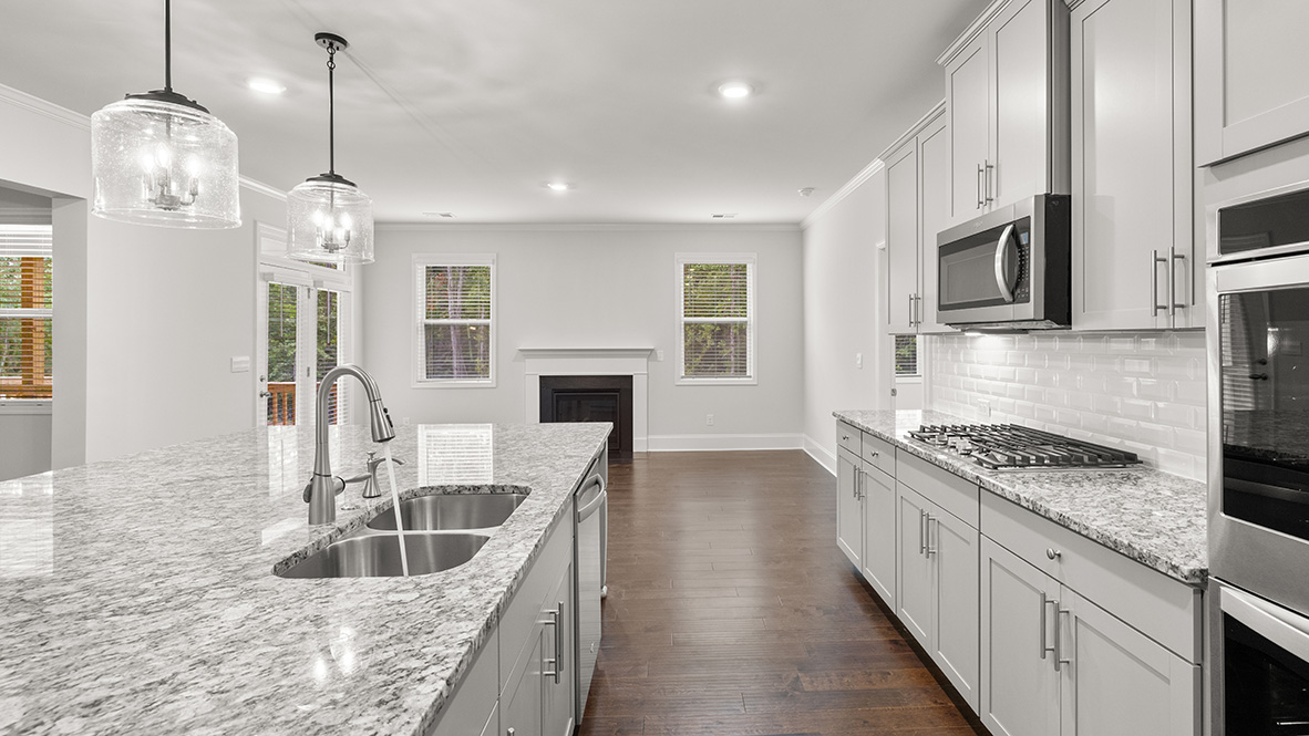 tisdale kitchen with large island and white cabinets at genesee in newnan georgia