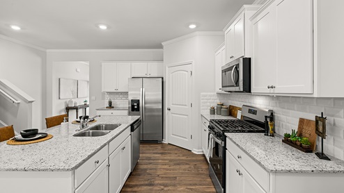 model home open kitchen with large island in the braselton village in braselton georgia