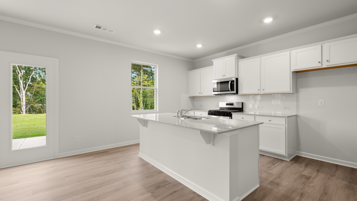 Interior kitchen with center island and white cabinets