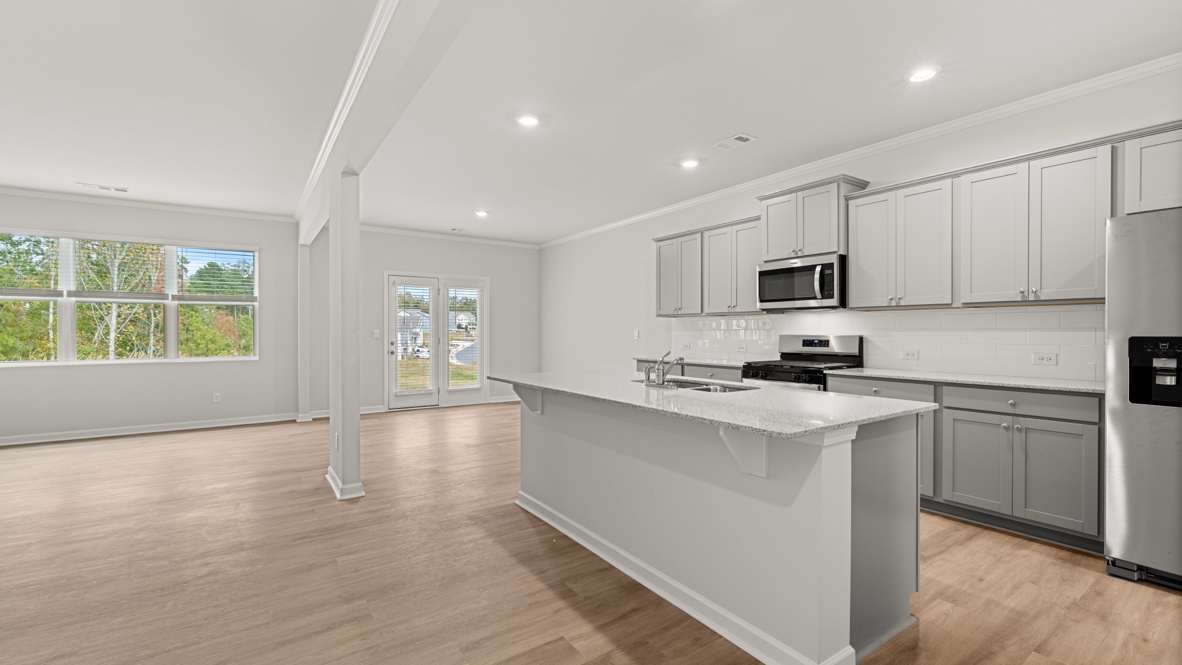 Interior kitchen with center island and light grey cabinets