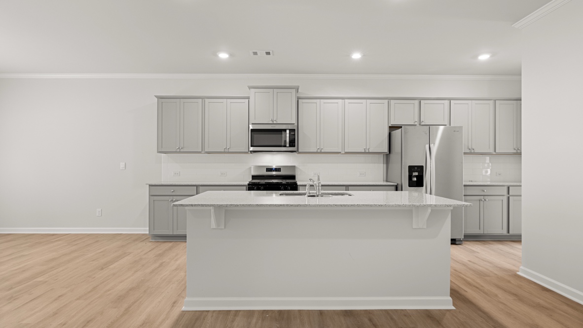 Interior kitchen with center island and light grey cabinets