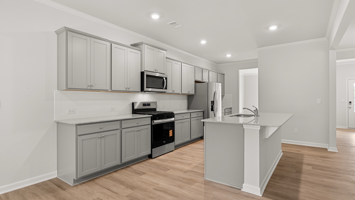 Interior kitchen with center island and light grey cabinets