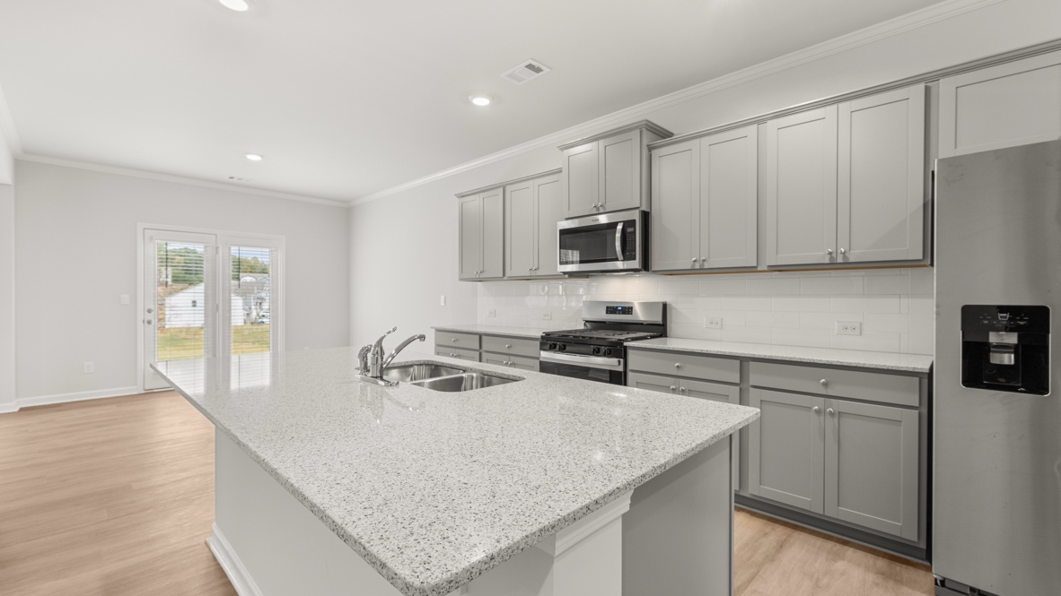 Interior kitchen with center island and light grey cabinets