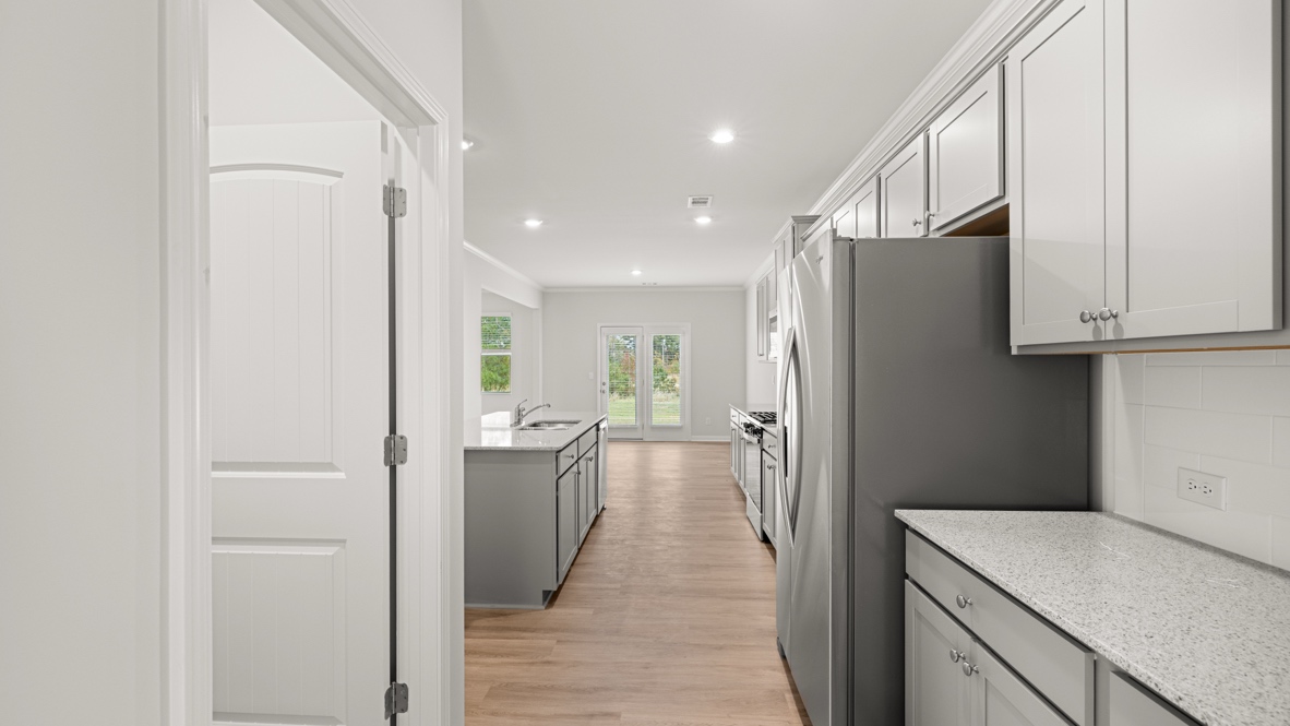 Interior kitchen with center island and light grey cabinets