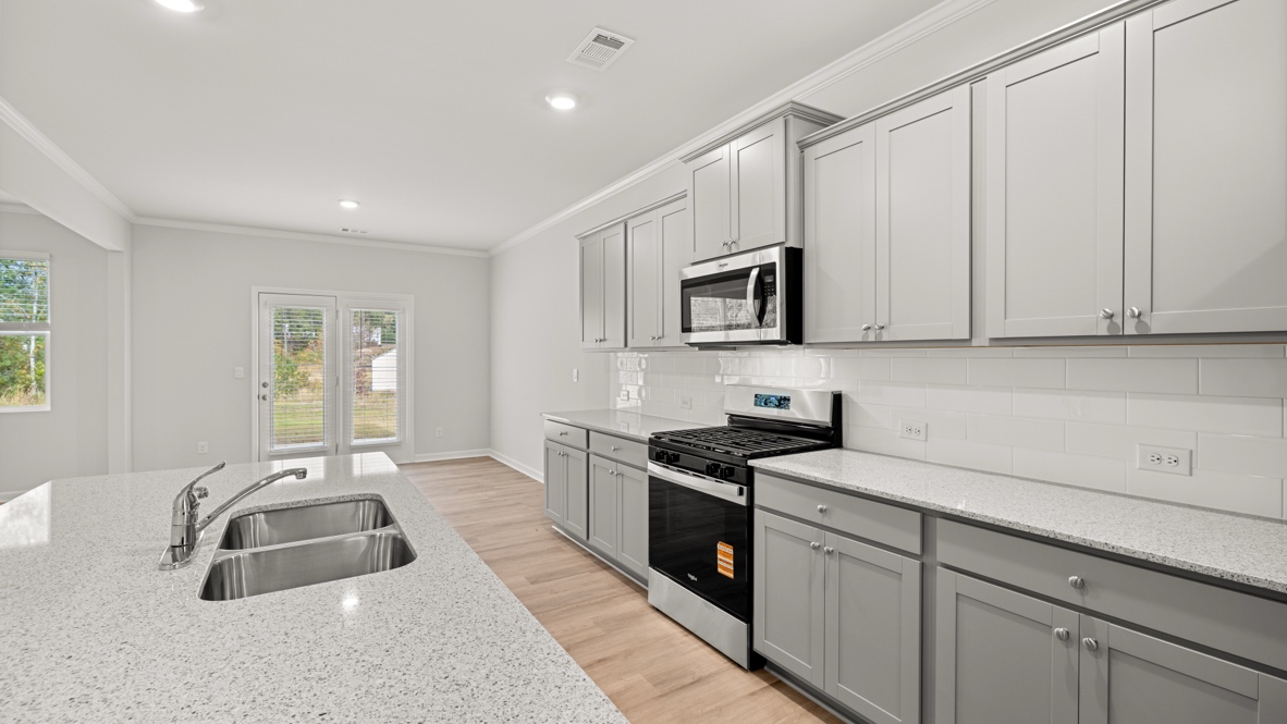 Interior kitchen with center island and light grey cabinets