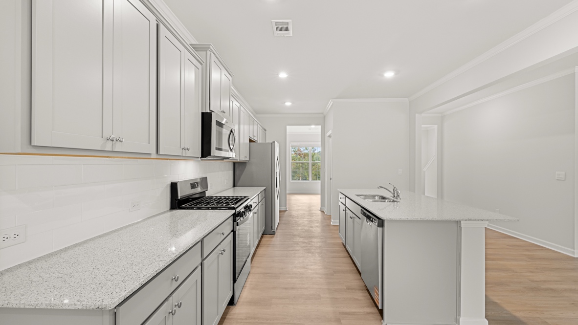 Interior kitchen with center island and light grey cabinets