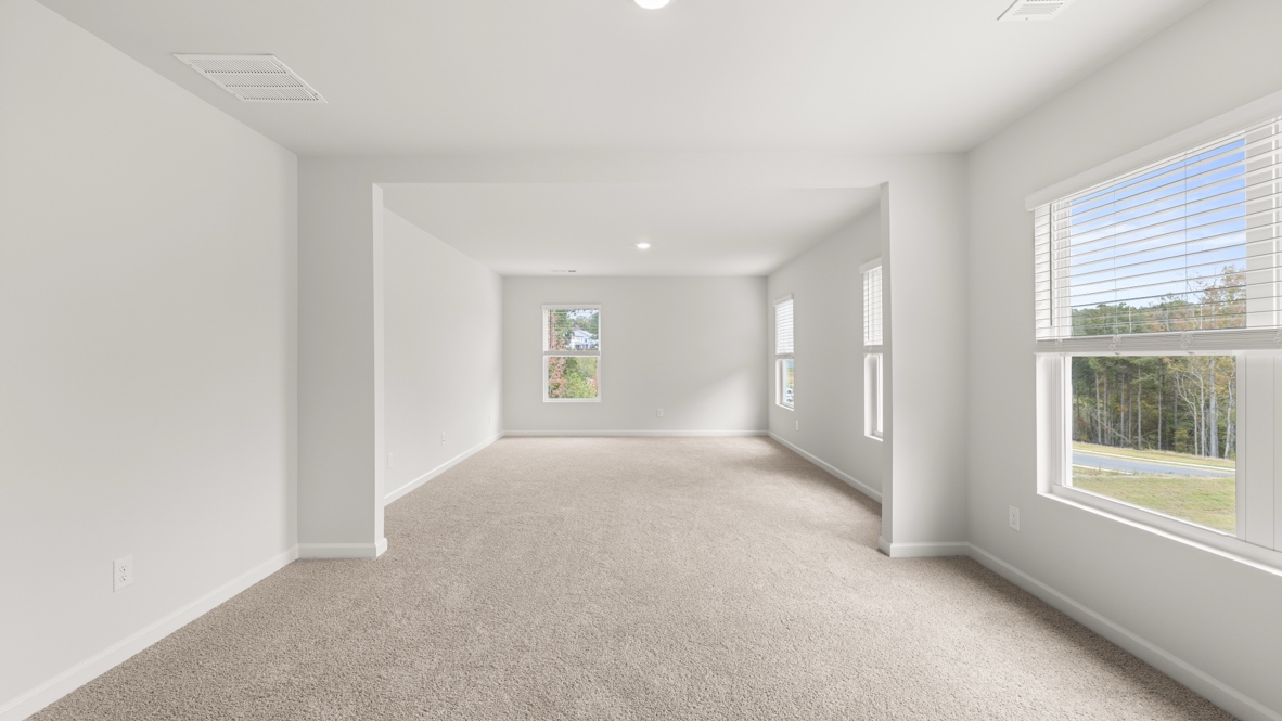 Interior primary bedroom with large windows