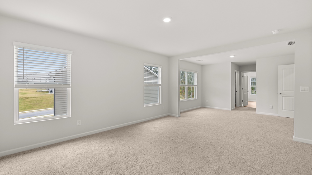 Interior primary bedroom with large windows