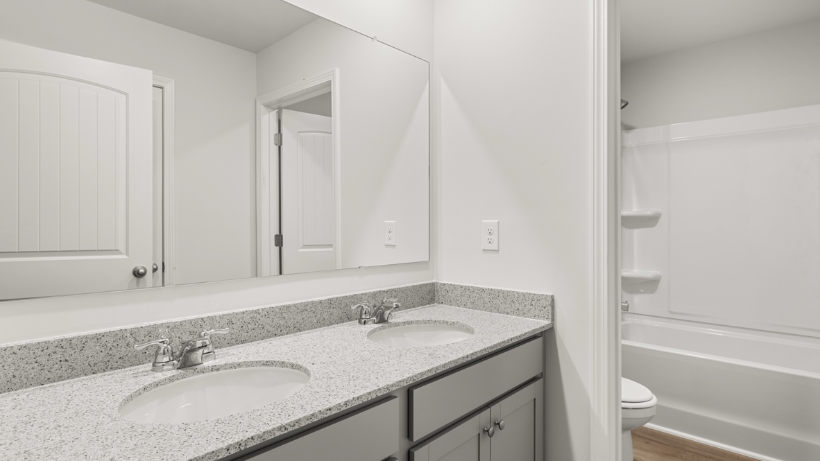 Interior bathroom with double sink and full-sized shower