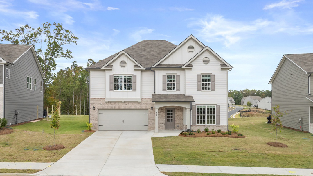 Halton Plan Front exterior of a two story home with grey siding, stone accents and a 2 car garage