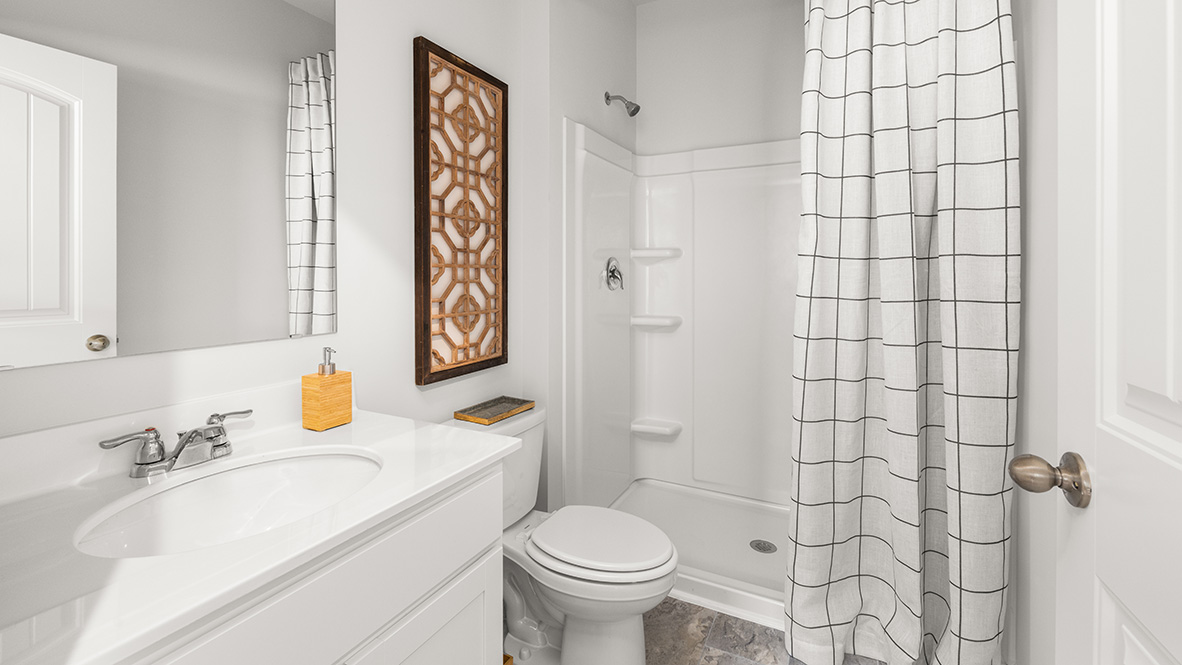 Secondary bathroom in Hanover Plan offering shared space with dual sinks by D.R. Horton in Lost Creek