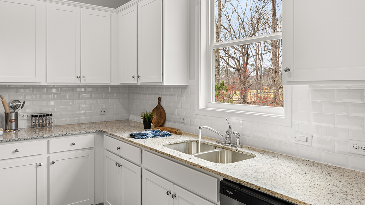 Centrally located kitchen in Hanover Plan at Lost Creek Dallas Georgia with Modern Design and walk-in pantry by D.R. Horton