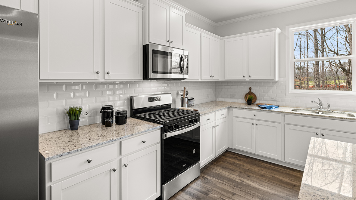 D.R. Horton-designed Hanover Plan kitchen in Lost Creek Dallas Georgia featuring Brand New Stainless Steel appliances and storage space