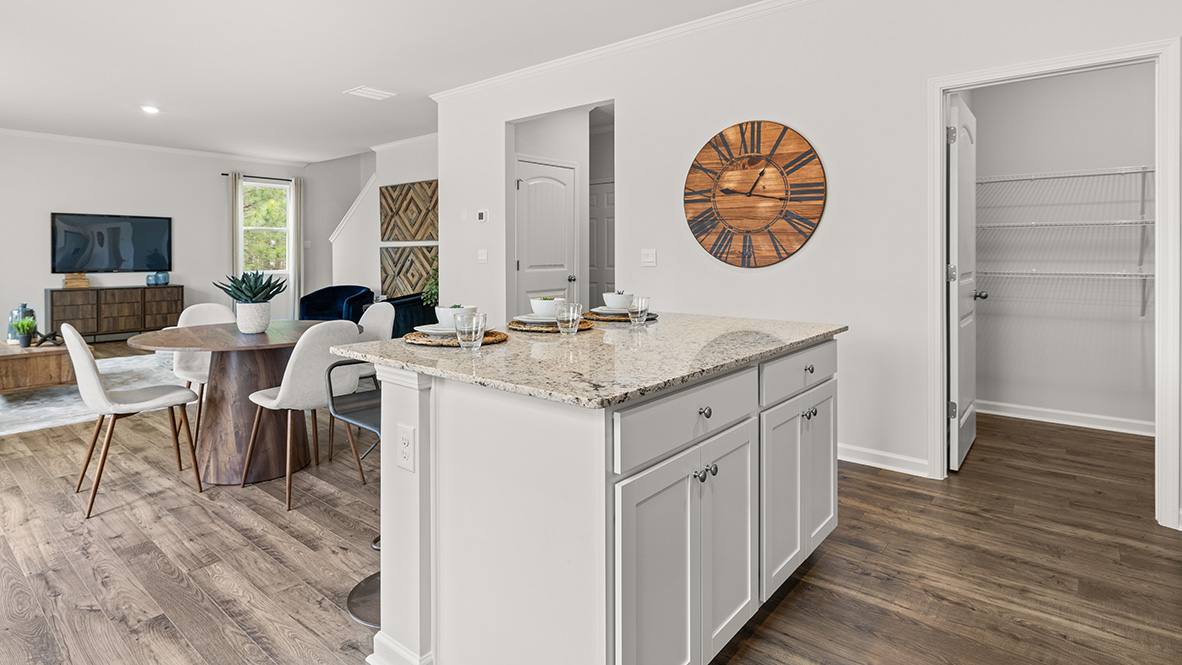 Your New Home kitchen inside Hanover Plan by D.R. Horton with spacious island and Fresh Open Concept layout into living room