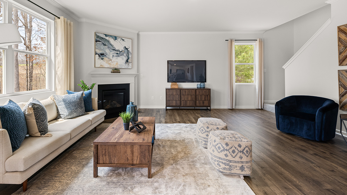 living room with a beige sofa and blue accent chairs