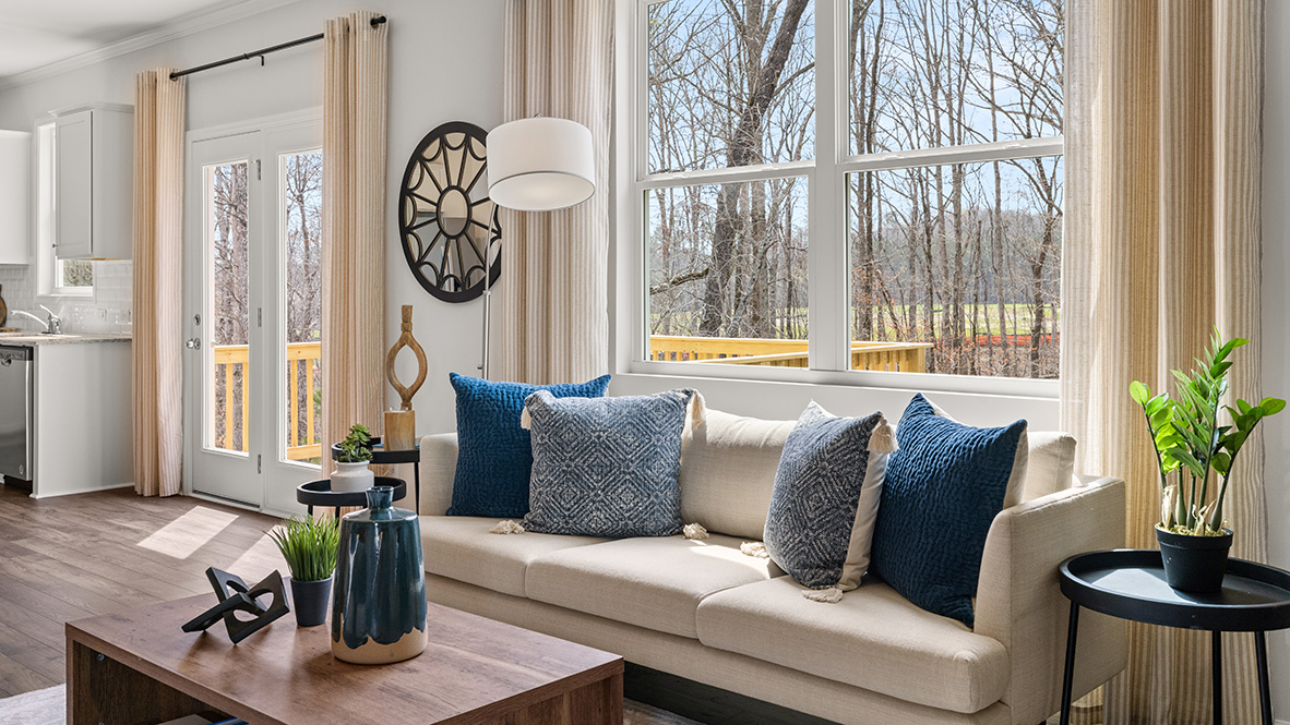living room with a beige sofa and blue accent chairs
