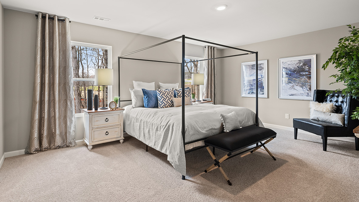 Primary bedroom in Hanover Plan crafted by D.R. Horton with carpeted flooring and private retreat feel in Lost Creek