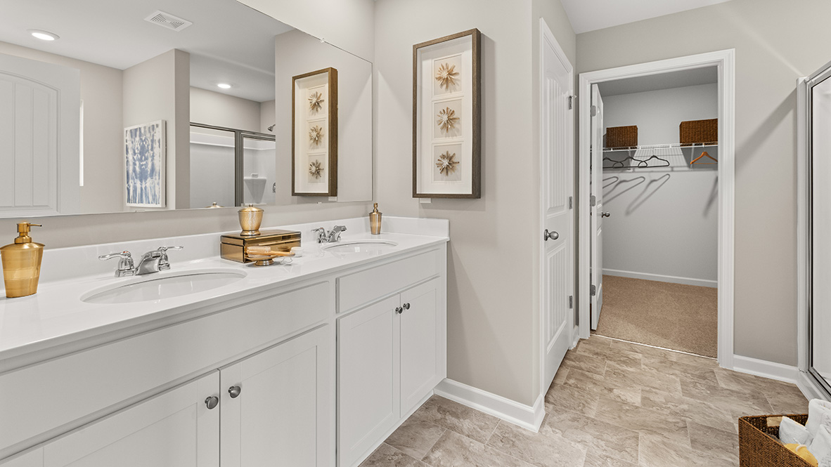 The Hanover Plan primary bedroom showing restful layout and direct connection to en suite bathroom by D.R. Horton