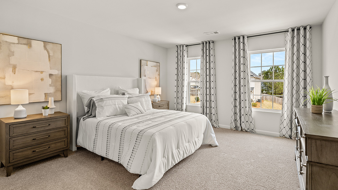 New Construction Home by D.R. Horton in Lost Creek featuring Hanover Plan primary bedroom with Bed, dresser and mirror