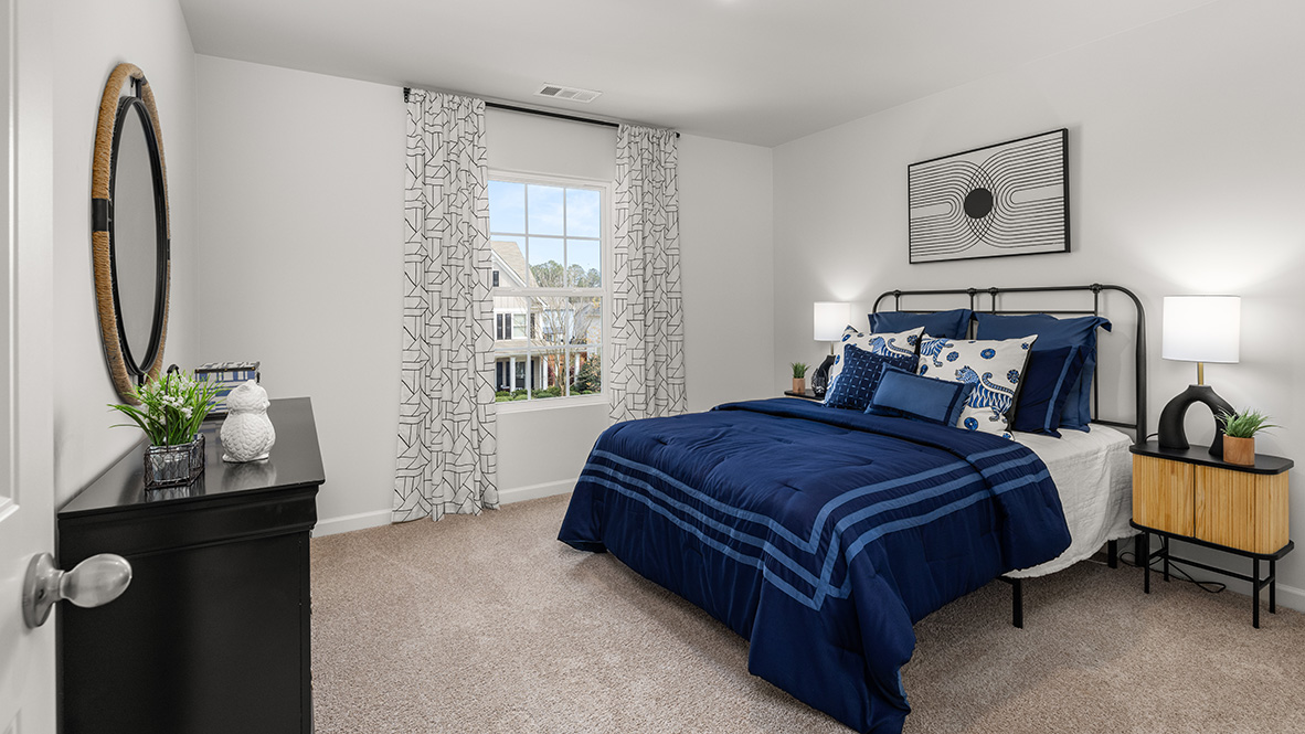 Hanover Plan primary bedroom showing restful layout and direct connection to en suite bathroom by D.R. Horton