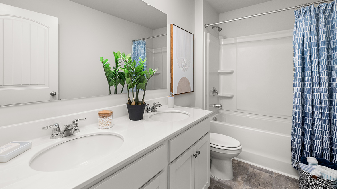 ack-and-Jill secondary bathroom in Hanover Plan offering shared space with dual sinks by D.R. Horton in Lost Creek