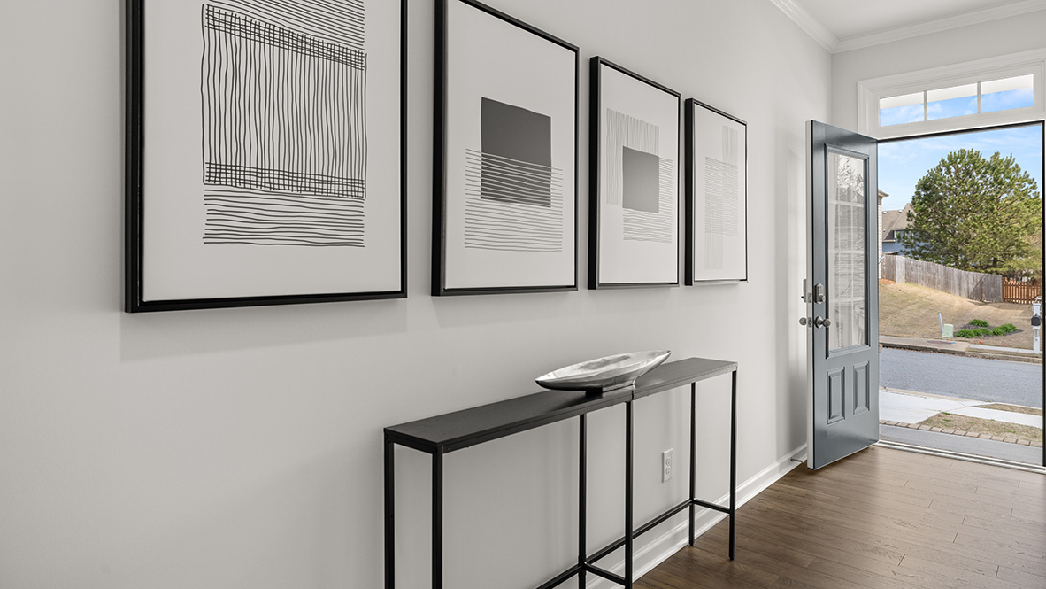 Front Entry D.R. Horton with welcoming hallway and access to guest bedrooms in Lost Creek