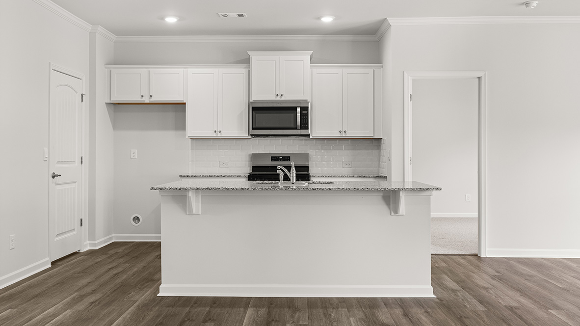 Interior kitchen with center island and white cabinets