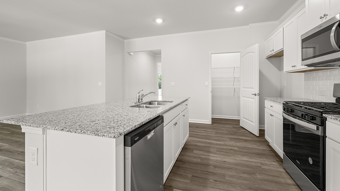 Interior kitchen with center island and white cabinets