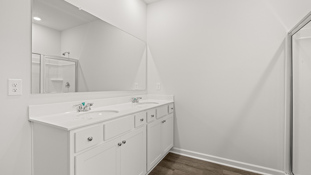 Interior primary bathroom with double sink and shower