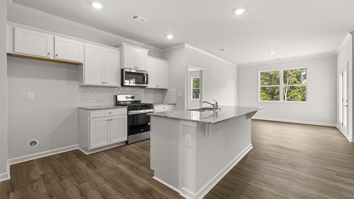 Interior kitchen with center island and white cabinets