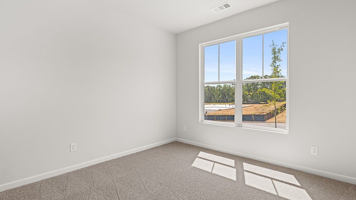 Main bedroom designed for privacy and space with clean lines and convenient flow into primary bathroom and closet